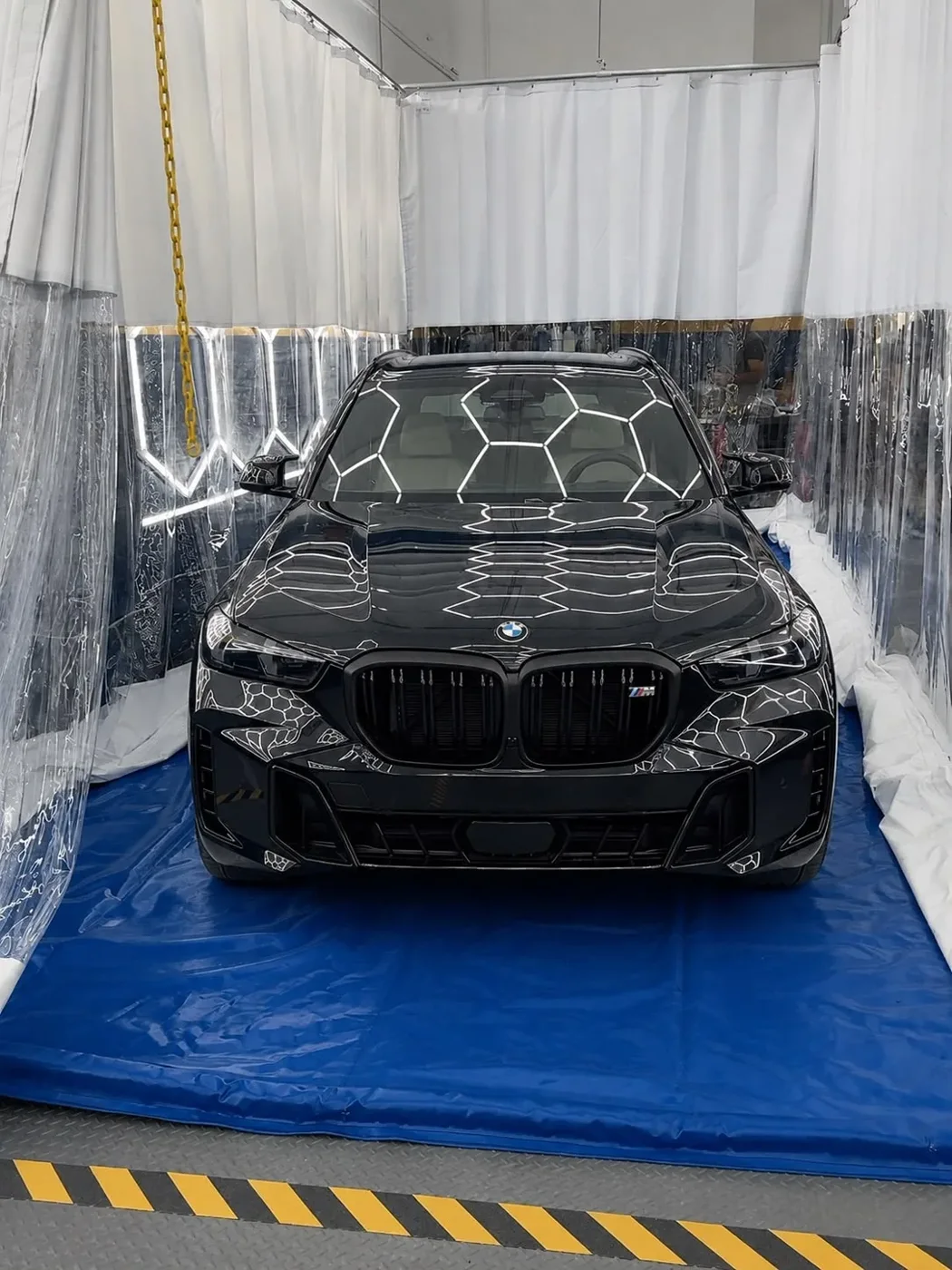 Black BMW inside A&A Quality Auto Spa's Richmond vehicle protection bay